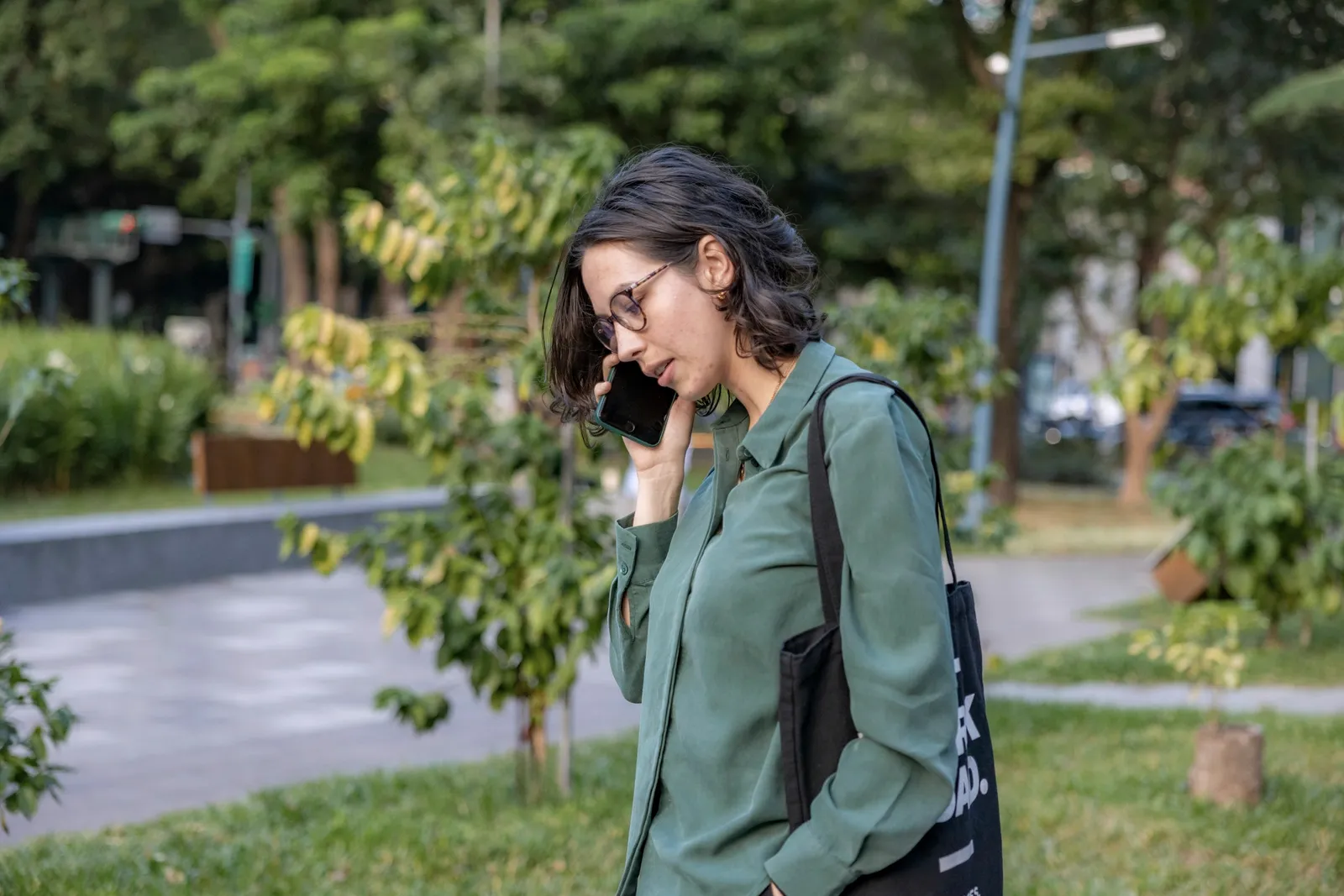 A woman on a phone call outdoors.